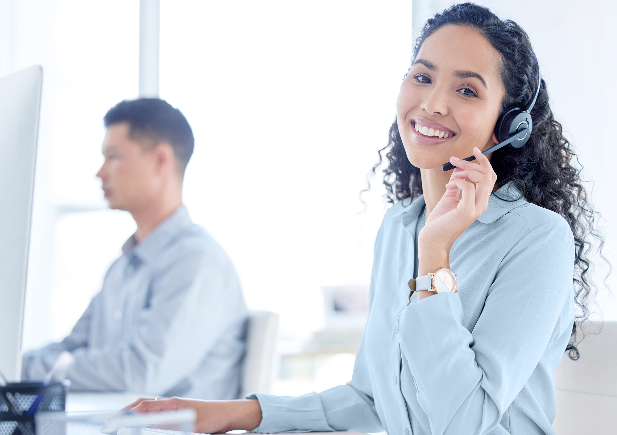Wide-edit-shot-of-a-young-call-centre-agent-sitting-with-her-2025-04-06-10-43-48-utc